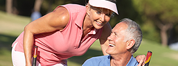 Smiling Eldery Couple Playing Golf